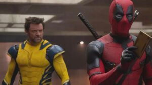 Wolverine (Hugh Jackman) with Deadpool (Ryan Reynolds) who is holding a TVA Tempad.