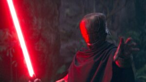 The masked Master with his hand out while holding a red lightsaber in the other on The Acolyte