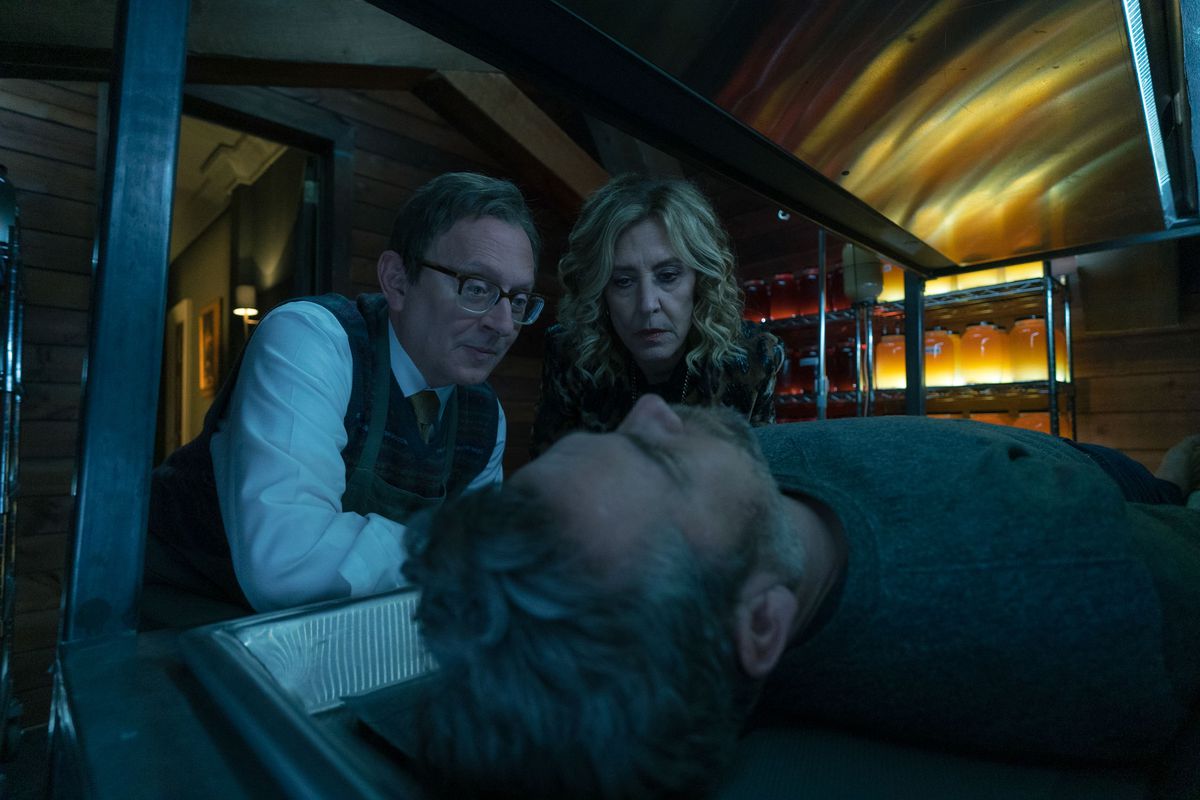 Dr. Leland Townsend looks pleased over the unconscious Andy Bouchard, with his accomplice Sheryl beside him in the fourth season of the series Evil.
