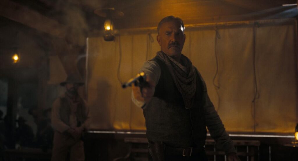 A man points a pistol in the Old West.