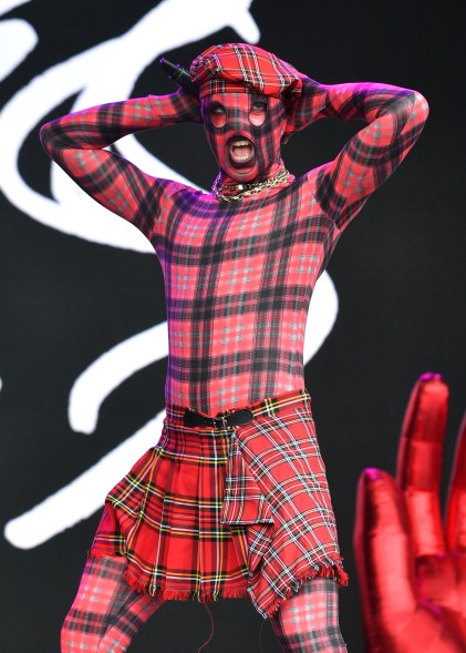 Lynks performing on the Park stage at the Glastonbury Festival 2024, wearing a plaid outfit