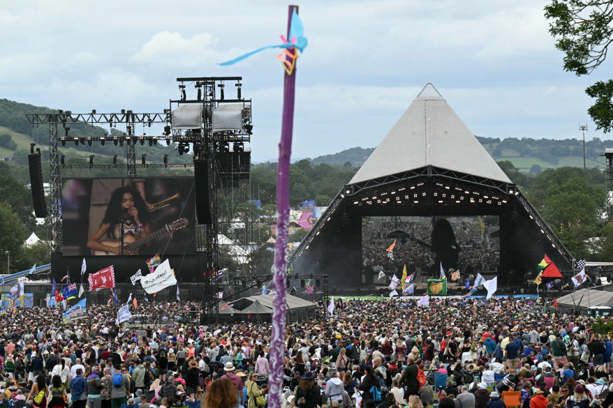 Festivalgoers watch as Olivia Dean performs on the Pyramid Stage.