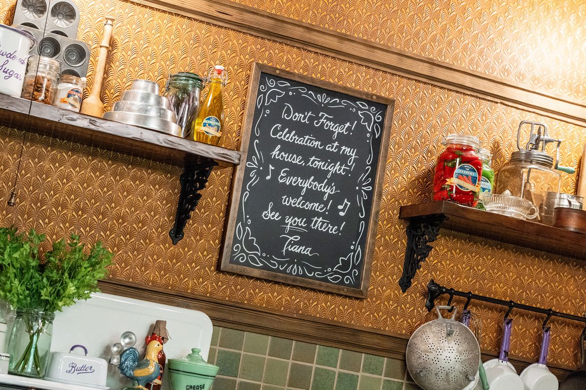 A set of Tiana’s kitchen, featuring a note on a chalkboard written by Tiana herself