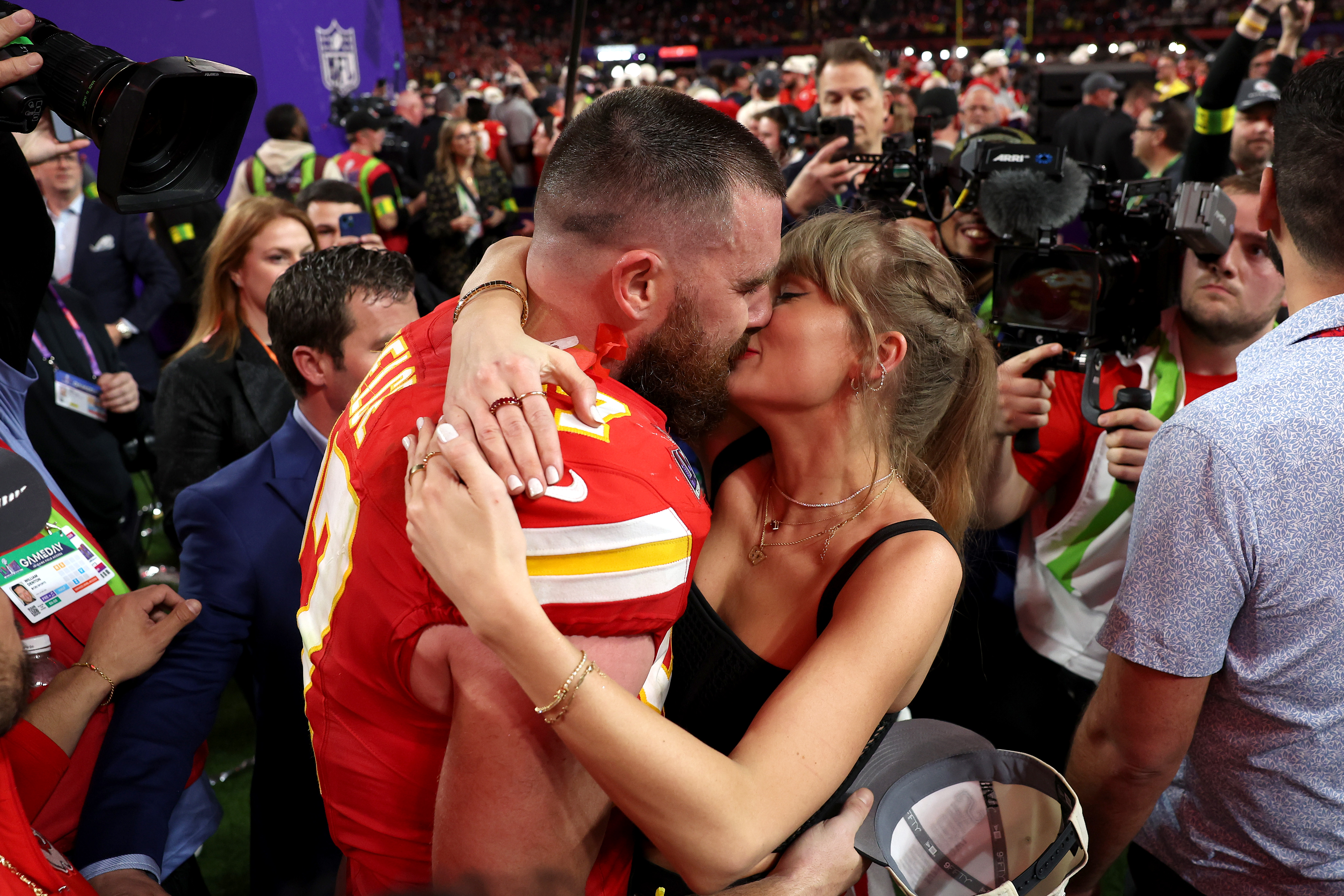 Taylor Swift rushing the field to embrace her boyfriend Travis Kelce after his Super Bowl LVIII win