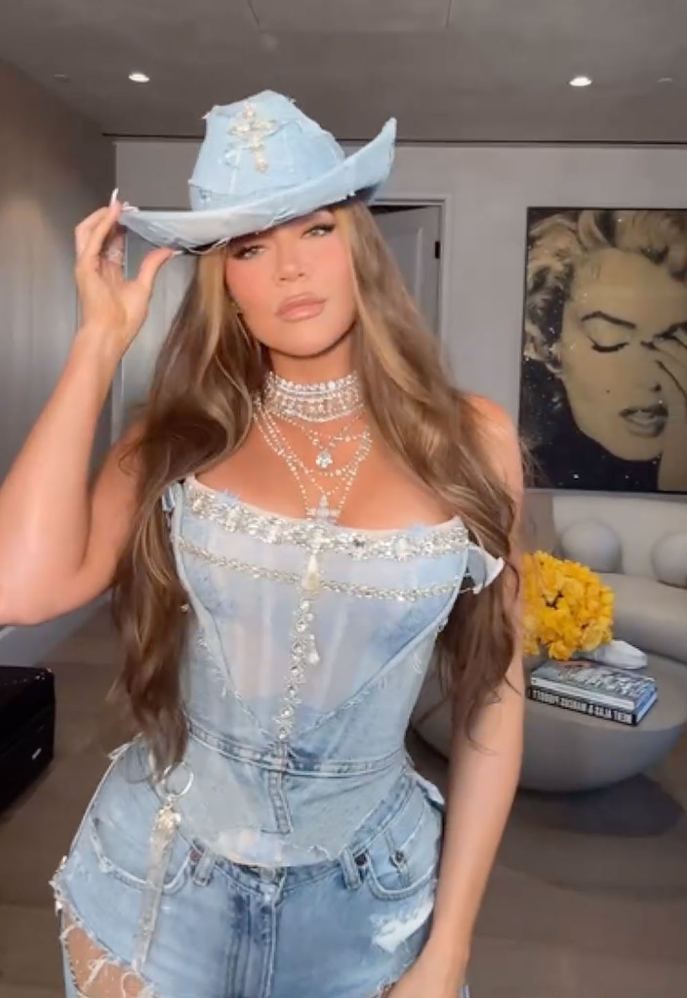 Khloe Kardashian sporting an all-denim outfit and a cowboy hat for her western-themed birthday bash
