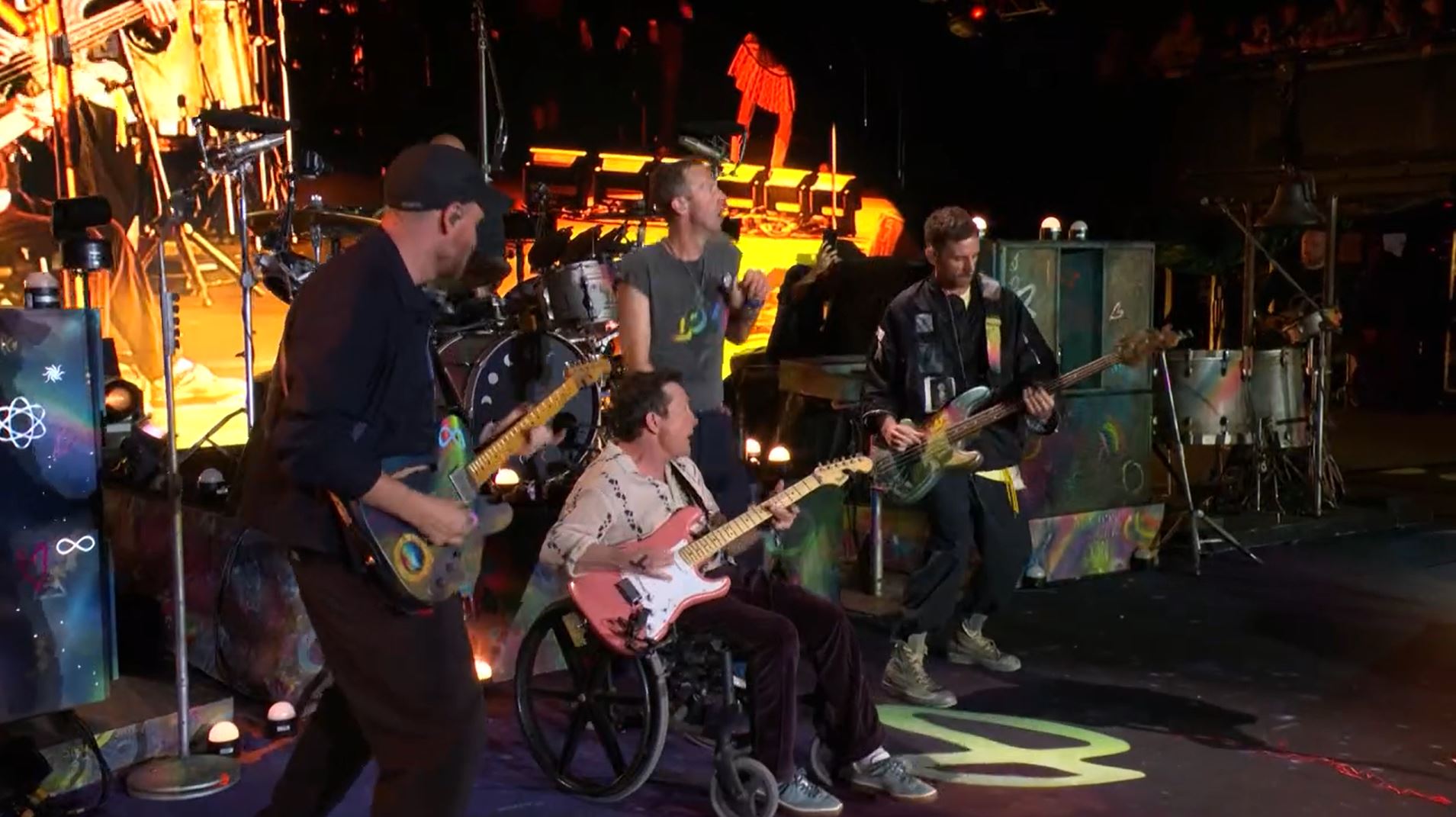 The actor — now in a wheelchair after 33 years with Parkinson’s disease — joined the band to play guitar to their 2005 hit Fix You