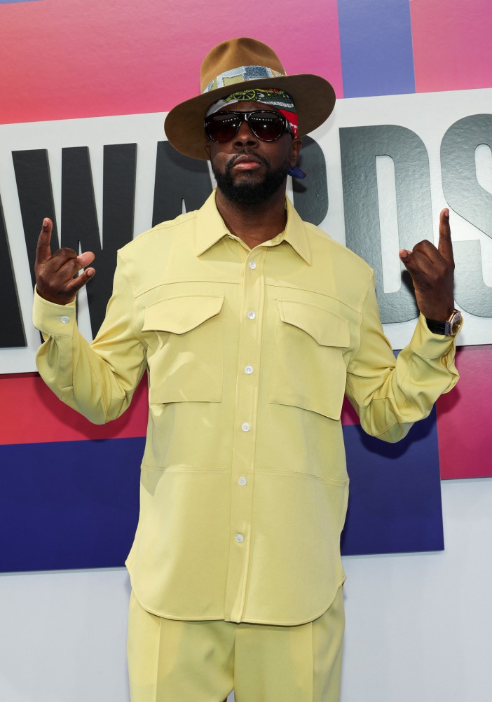 Wyclef Jean arrived at the BET Awards in a bright banana yellow ensemble