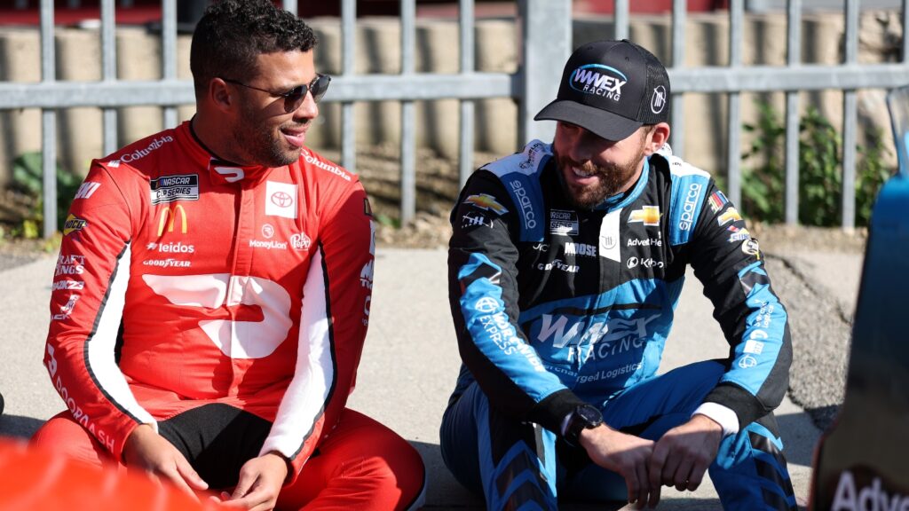 NASCAR racers Bubba Wallace and Aric Almirola talking