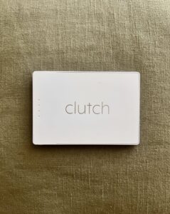 Photo of the Clutch Pro Lightning Portable Charger perched on a green pillow