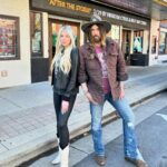 Firerose and Billy Ray Cyrus pose together outside The Franklin Theatre