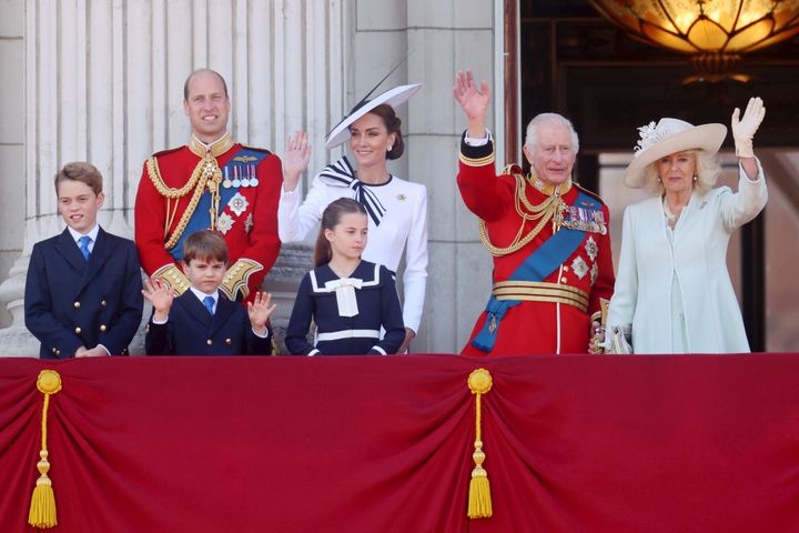 From left: Prince George of Wales; Prince William, Prince of Wales; Prince Louis of Wales; Princess Charlotte of Wales; Catherine, Princess of Wales; King Charles III and Queen Camilla. The royal family appears on a balcony during Trooping the Color at Buckingham Palace. The event features over 1,400 soldiers and officers, accompanied by 200 horses. More than 400 musicians from ten different bands and Corps of Drums march and perform in perfect harmony.