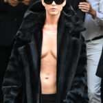 Katy Perry wearing no shirt and a fur coat at the Balenciaga Haute Couture Fall/Winter 2024-2025 show