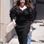Melissa McCarthy has shown off her dramatic weight loss in a tight black ruched dress and open-toed leather heels