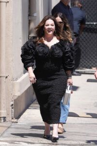 Melissa McCarthy has shown off her dramatic weight loss in a tight black ruched dress and open-toed leather heels
