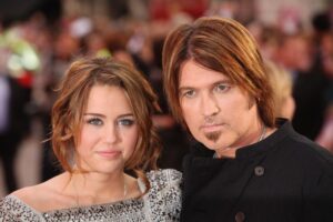 Miley Cyrus and her father, Billy Ray Cyrus, arrive at the film premiere of "Hannah Montana: The Movie" on April 23, 2009, in London.