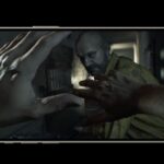 iPhone running resident evil 7, first person view with hands defensively held out against an enemy,