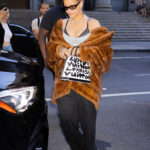 Rihanna was recently seen wearing a large fur coat and using her purse to cover her stomach during a hot New York City day