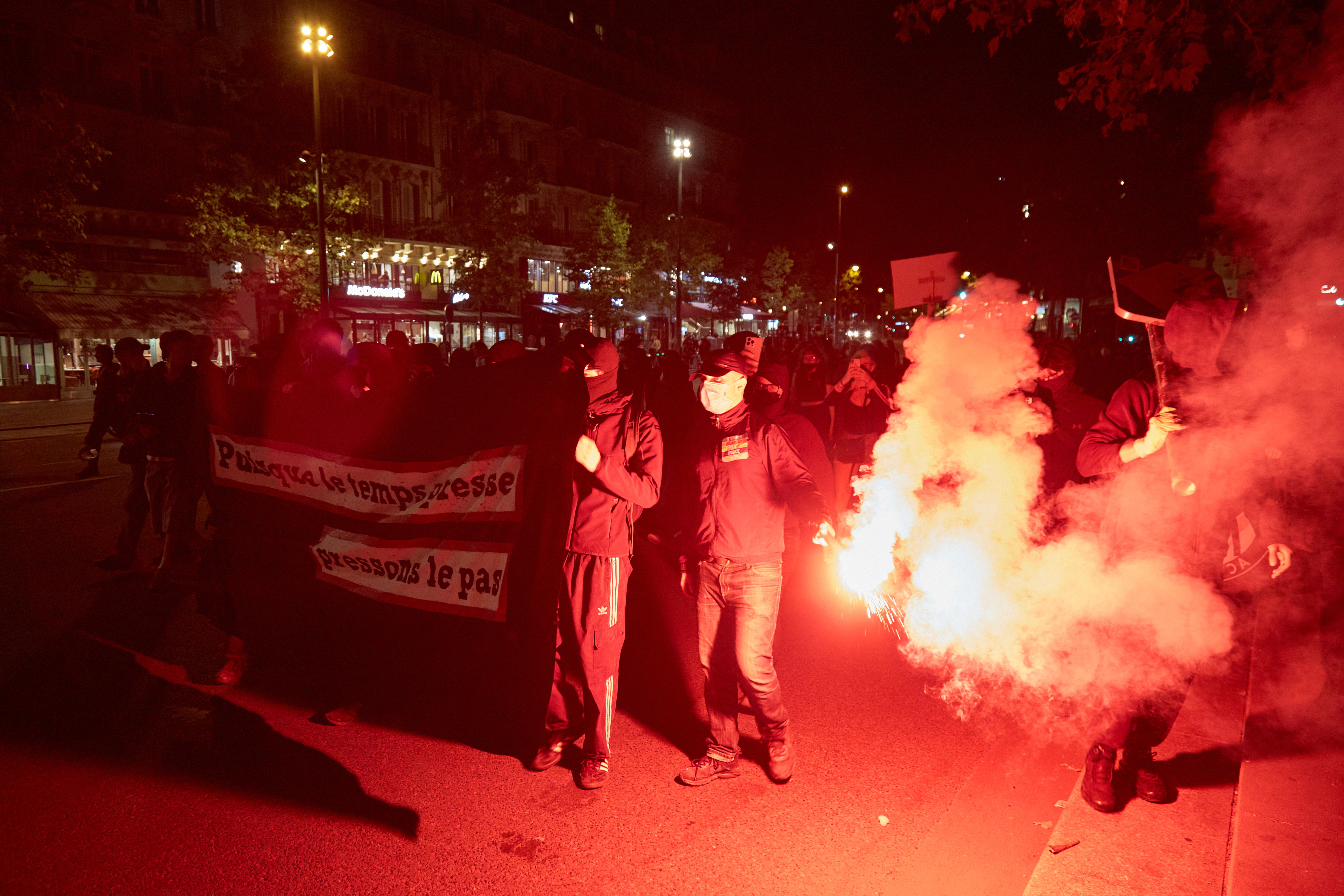Protesters set off flares as firefighters rushed to the scene on Sunday night