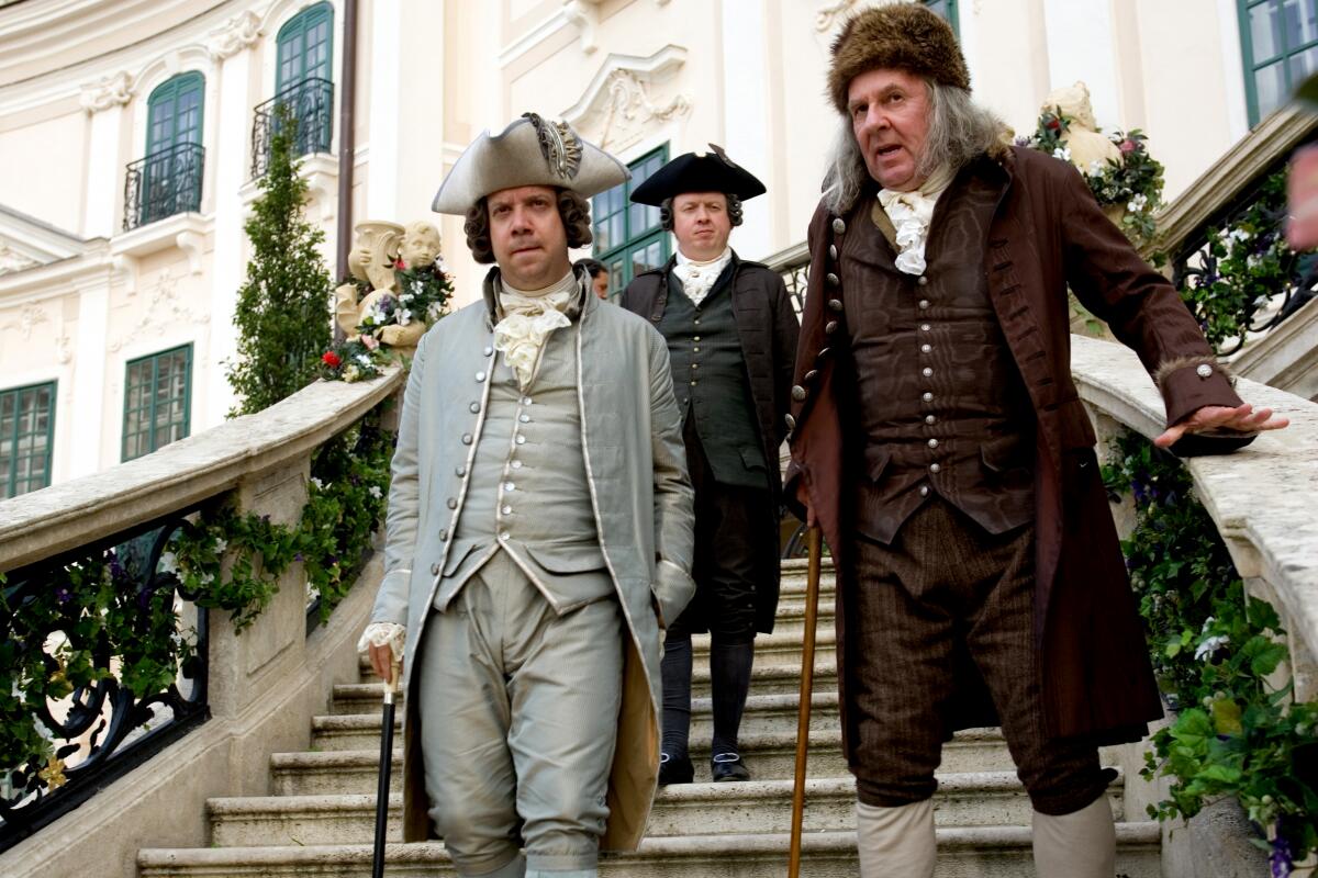 Paul Giamatti as John Adams and Tom Wilkinson as Benjamin Franklin walk down stairs in "John Adams."