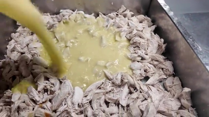 The 'secret sauce' and stock is added to the chicken