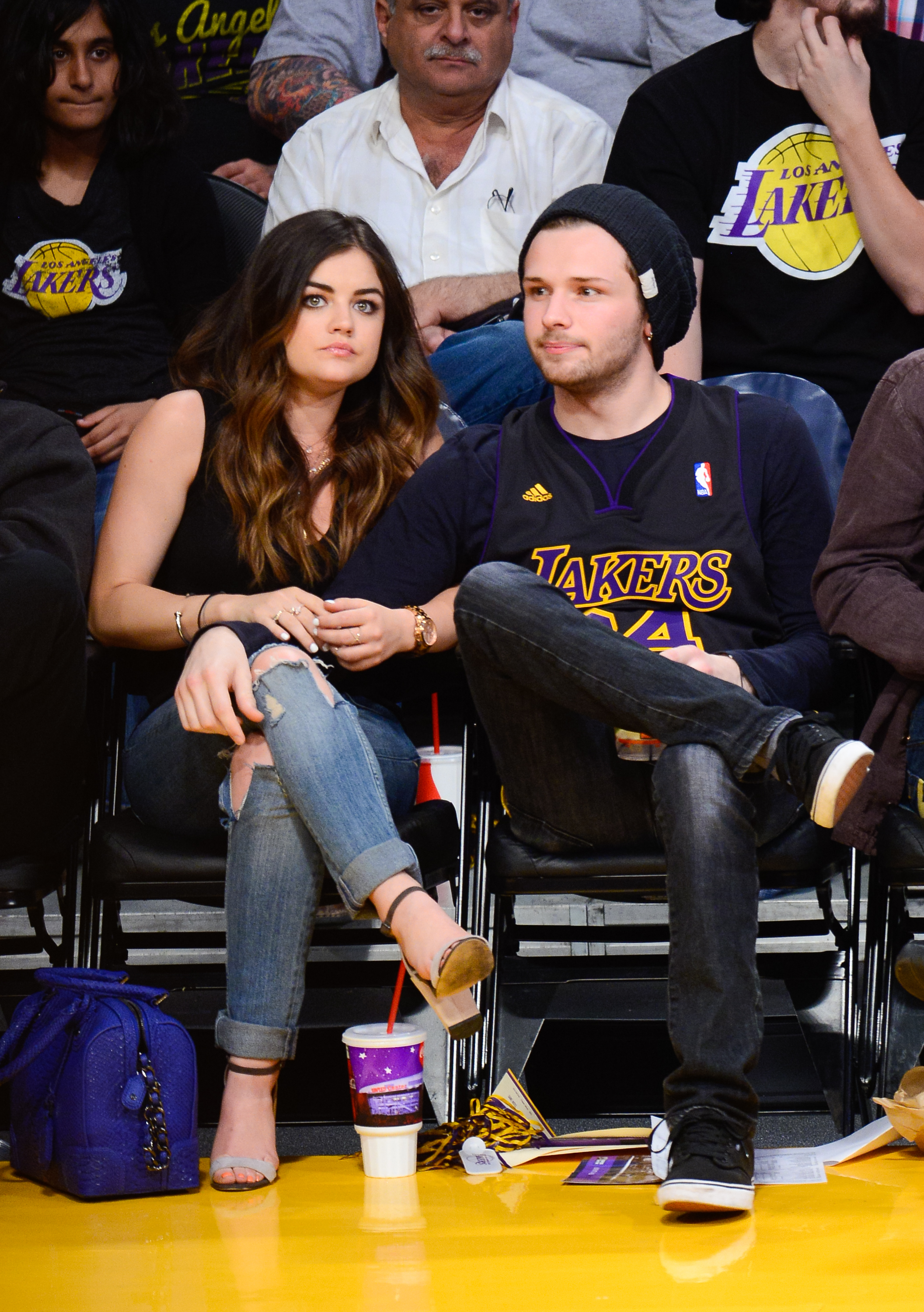 Lucy Hale and Joel Crouse sitting courtside at a basketball game between the Memphis Grizzlies and the Los Angeles Lakers at Staples Center on April 13, 2014