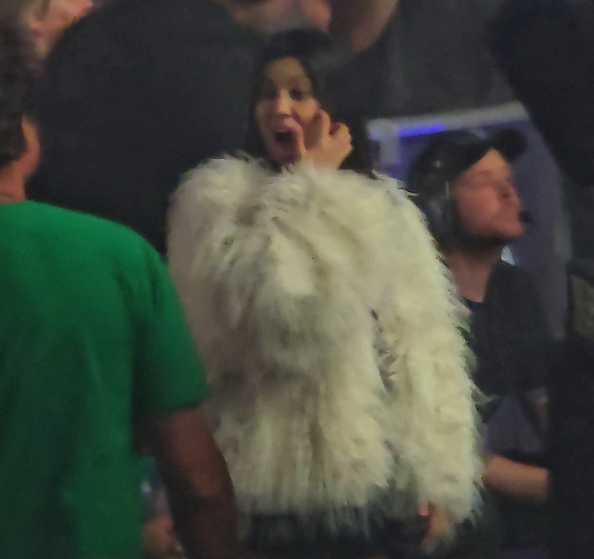 Kourtney Kardashian yawning while watching her husband, Travis Barker, on stage with his band Blink-182