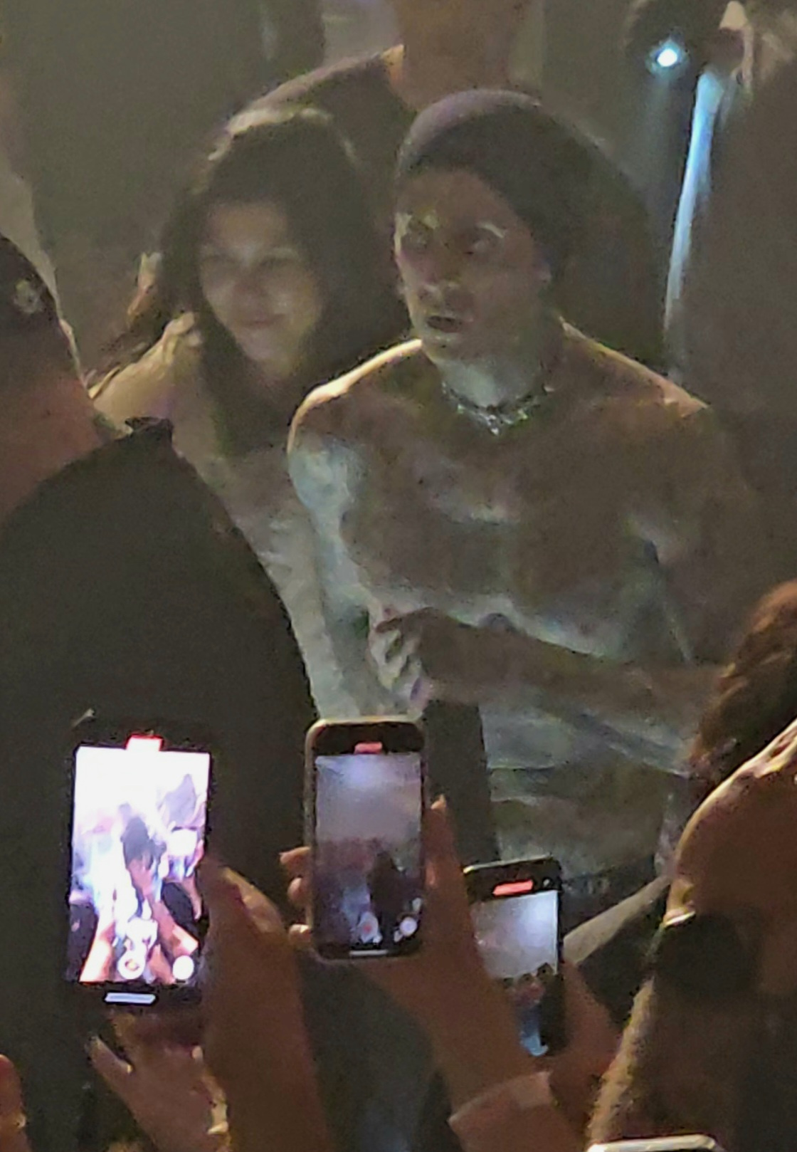 Kourtney Kardashian and her husband Travis Barker walking through the crowd at his band Blink-182's concert in Las Vegas