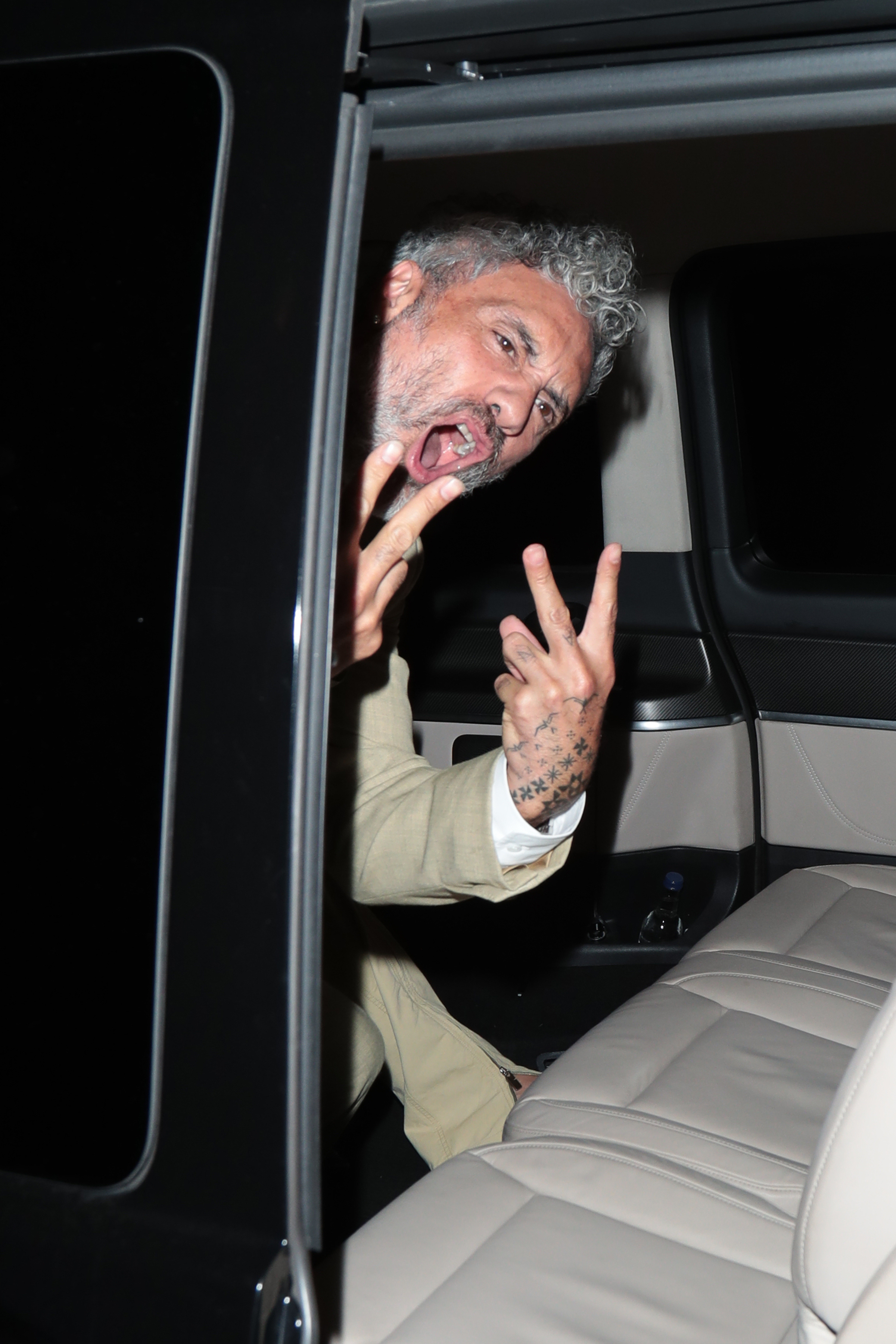 They were seen climbing into a car, with Taika making a V sign as they left