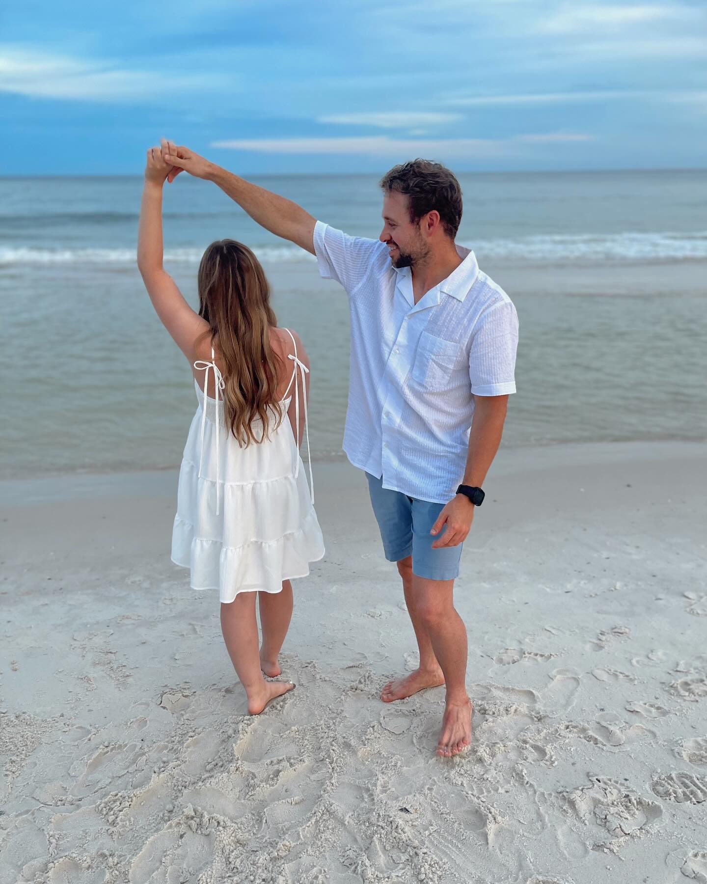 He shared photos of them twirling on a sandy beach, but did not reveal her identity