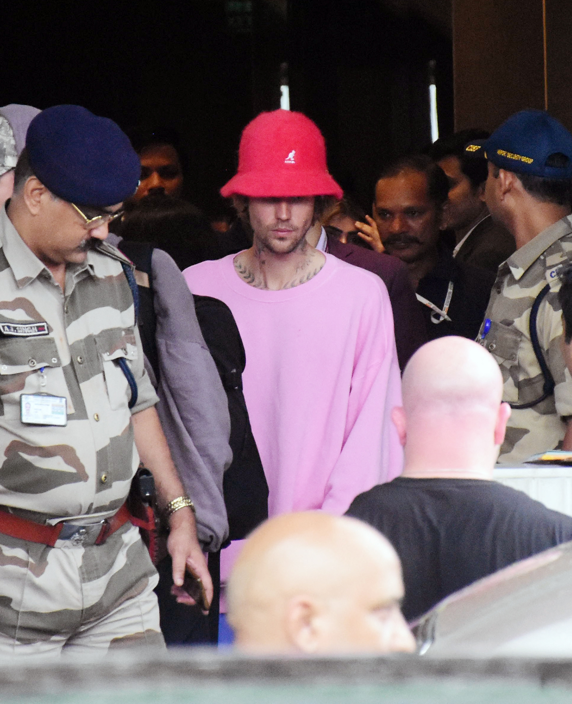 Justin Bieber navigating through the crowd at the Mumbai airport