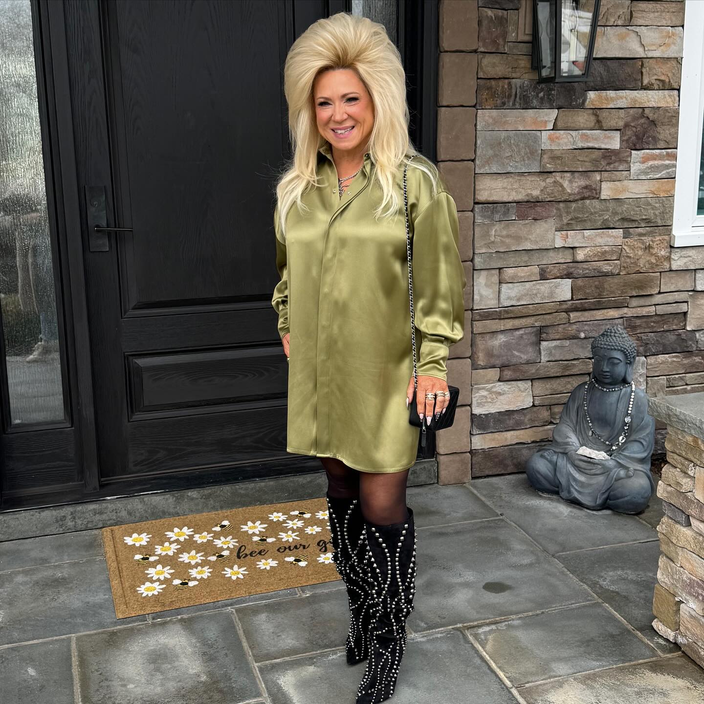 Above, Theresa Caputo poses outside a home wearing a green dress