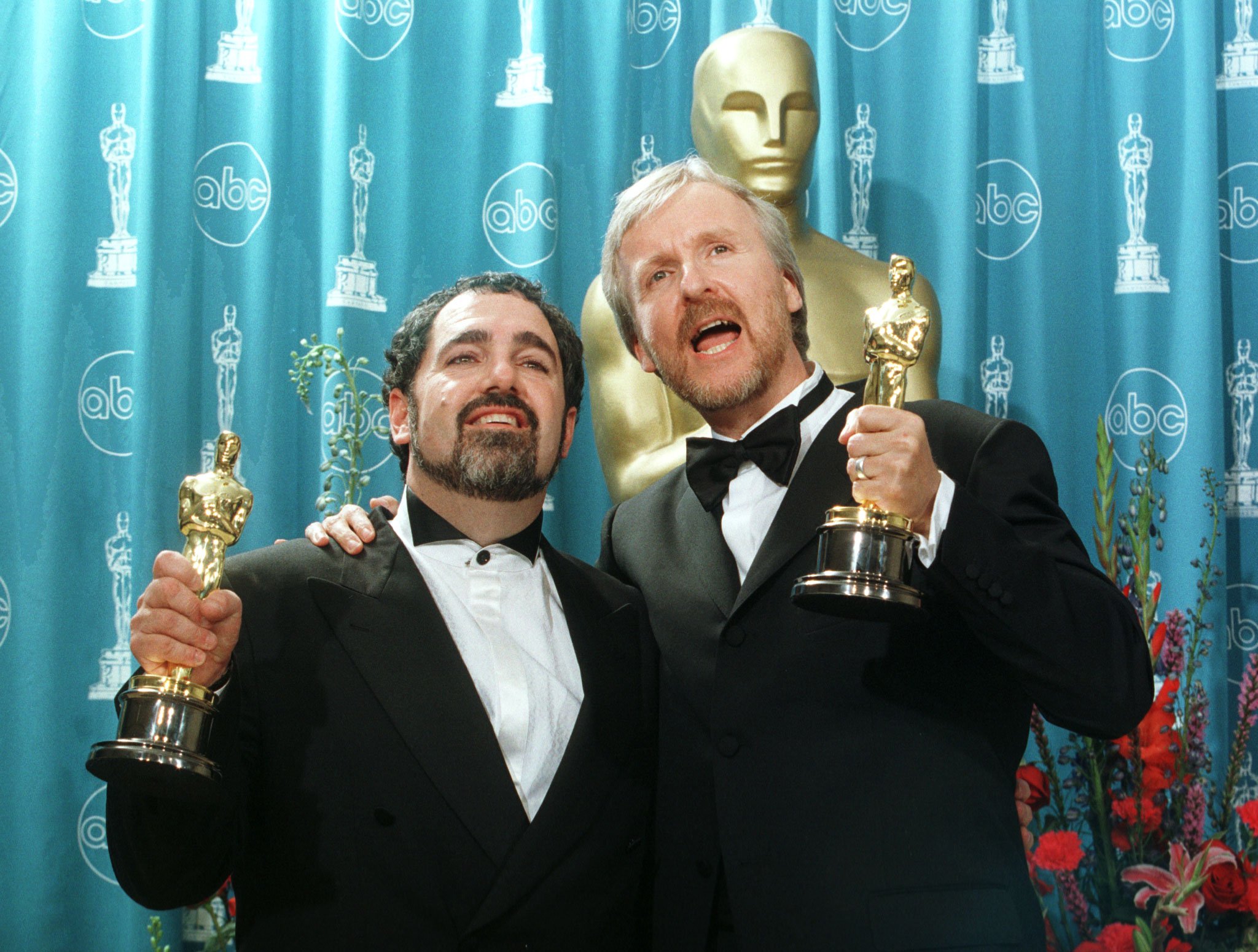 Director James Cameron, right, pictured with Jon Landau as the pair hold their Oscars after "Titanic" won best picture at the Annual Academy Awards