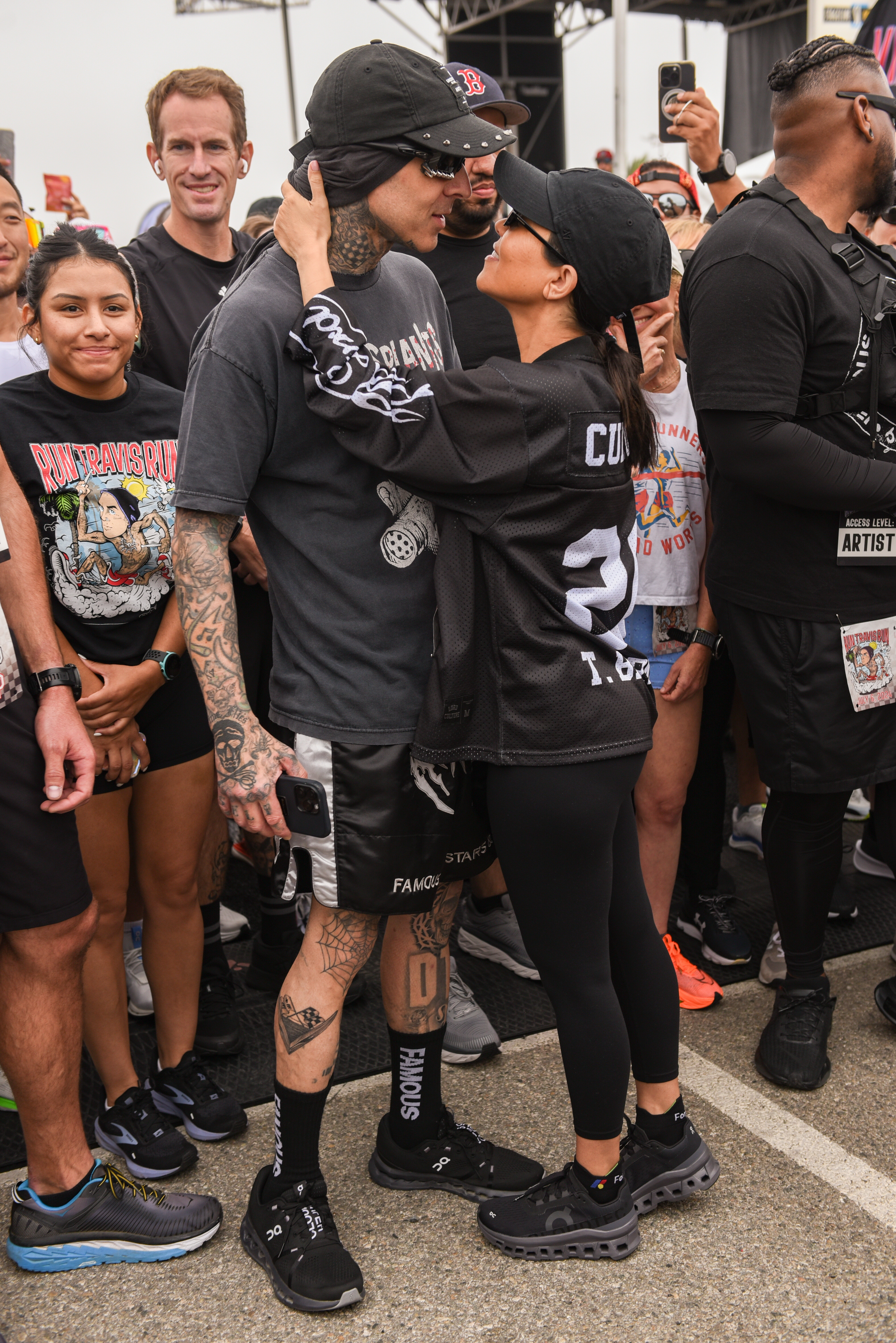 After Kourtney Kardashian finished the race, Travis Barker waited for her at the finish line with a hug and kiss