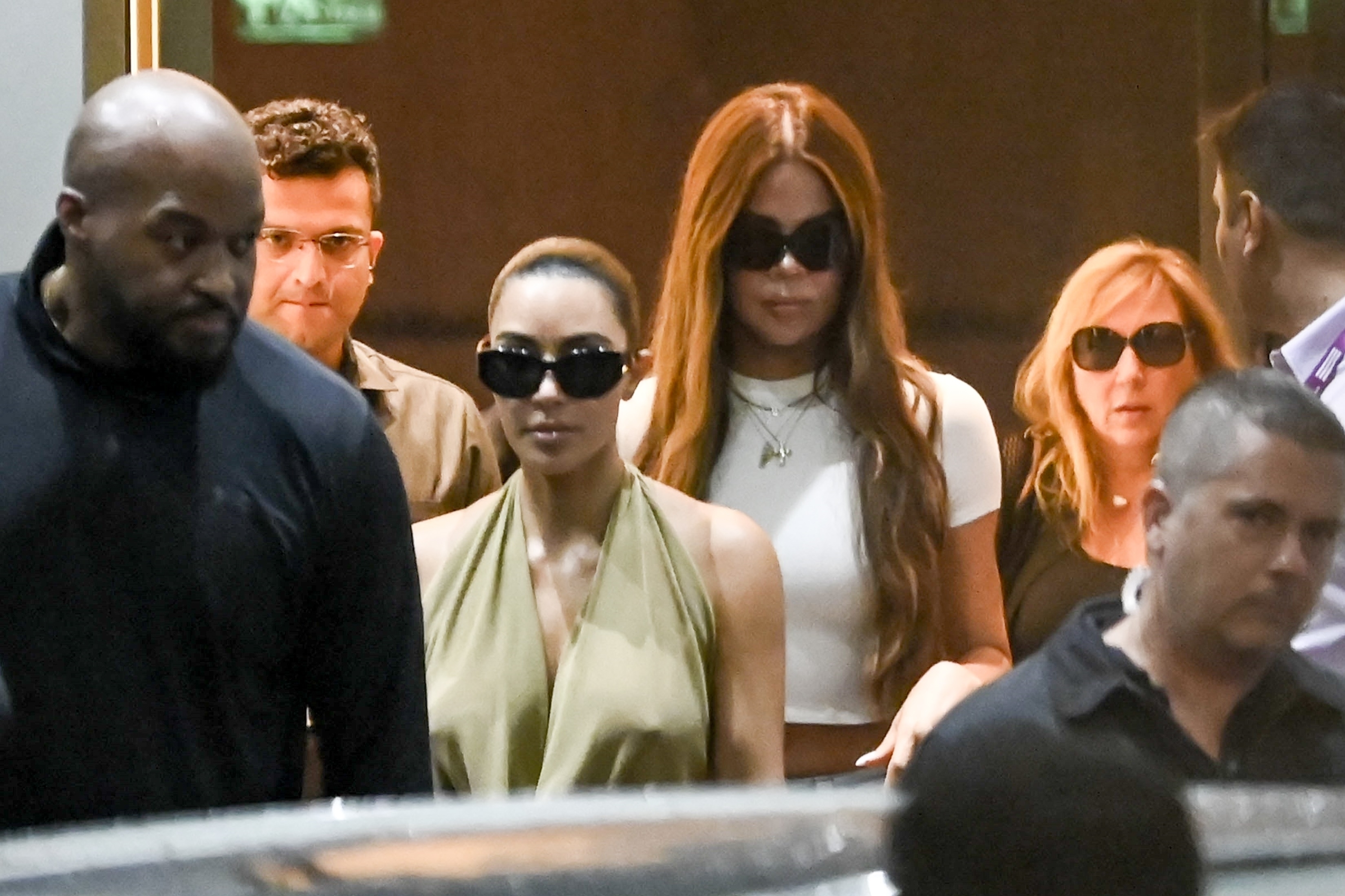 Kim Kardashian and Khloe Kardashian arriving at an airport in India to attend Anant Ambani's wedding