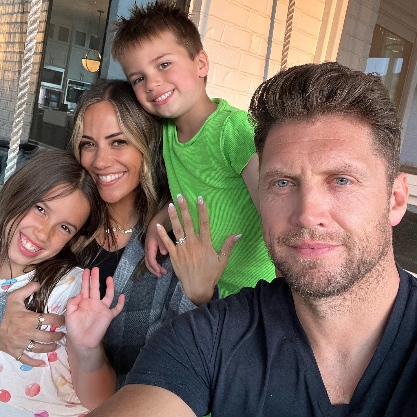 Jana Kramer shows off her engagement ring as she poses with her now-husband Allan Russell and her two kids, Jolie and Jace, in 2023