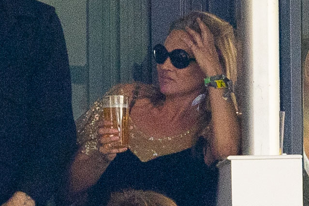 Kate appears to take a break from dancing so she can have a sip of her drink