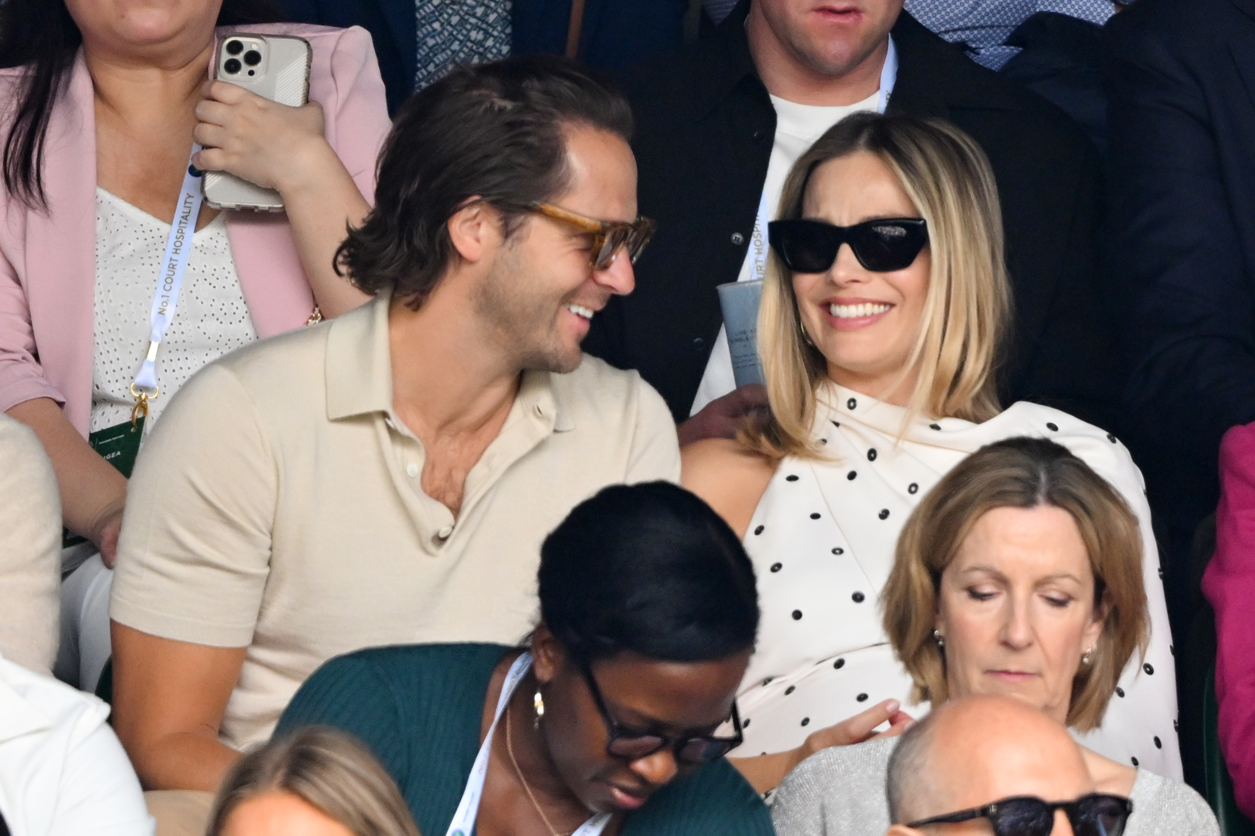 Margot and Tom were all smiles as they watched the match