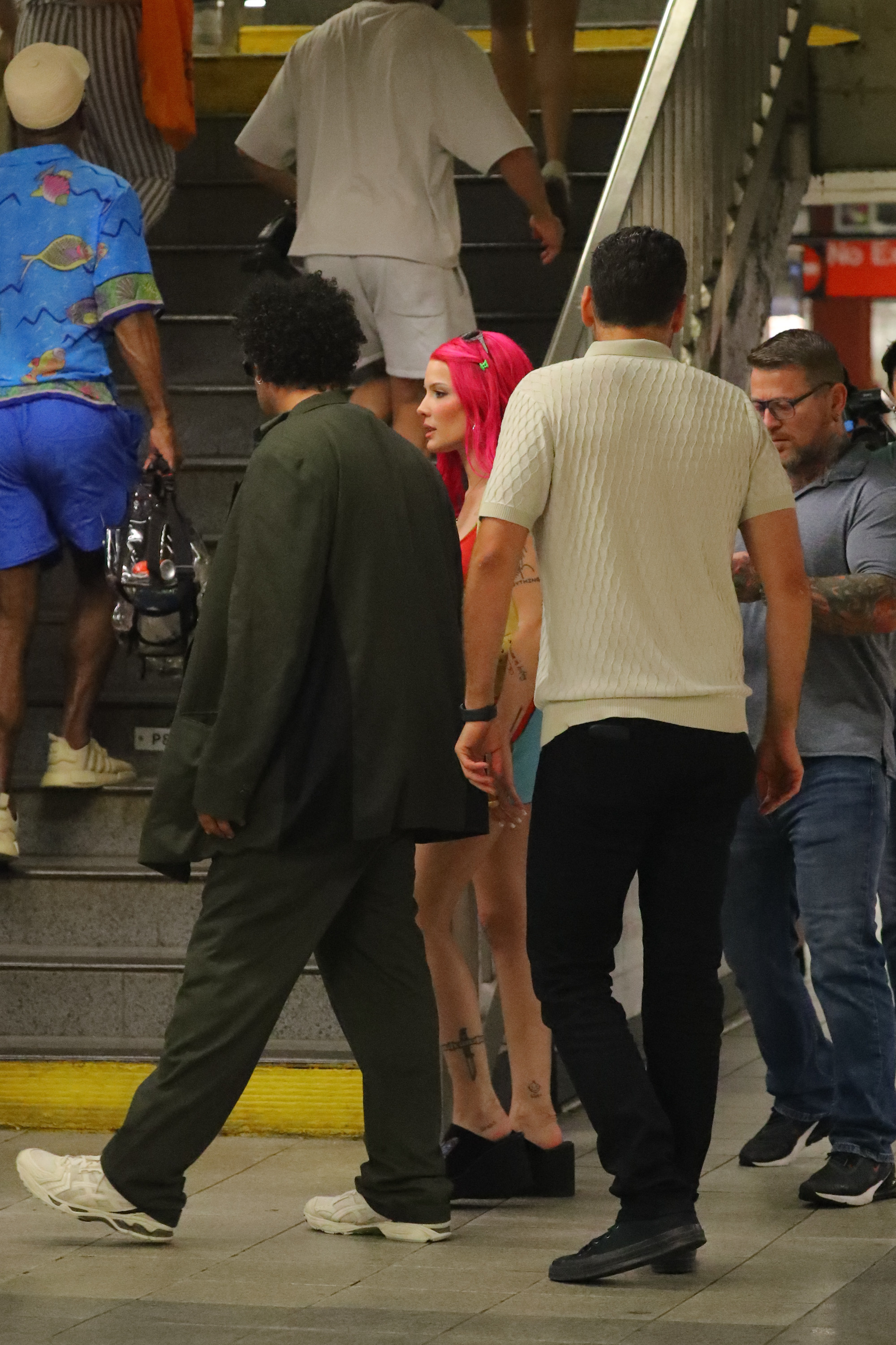 The singer was seen filming the music video in a subway in a multi-colored dress and black slip-on shoes