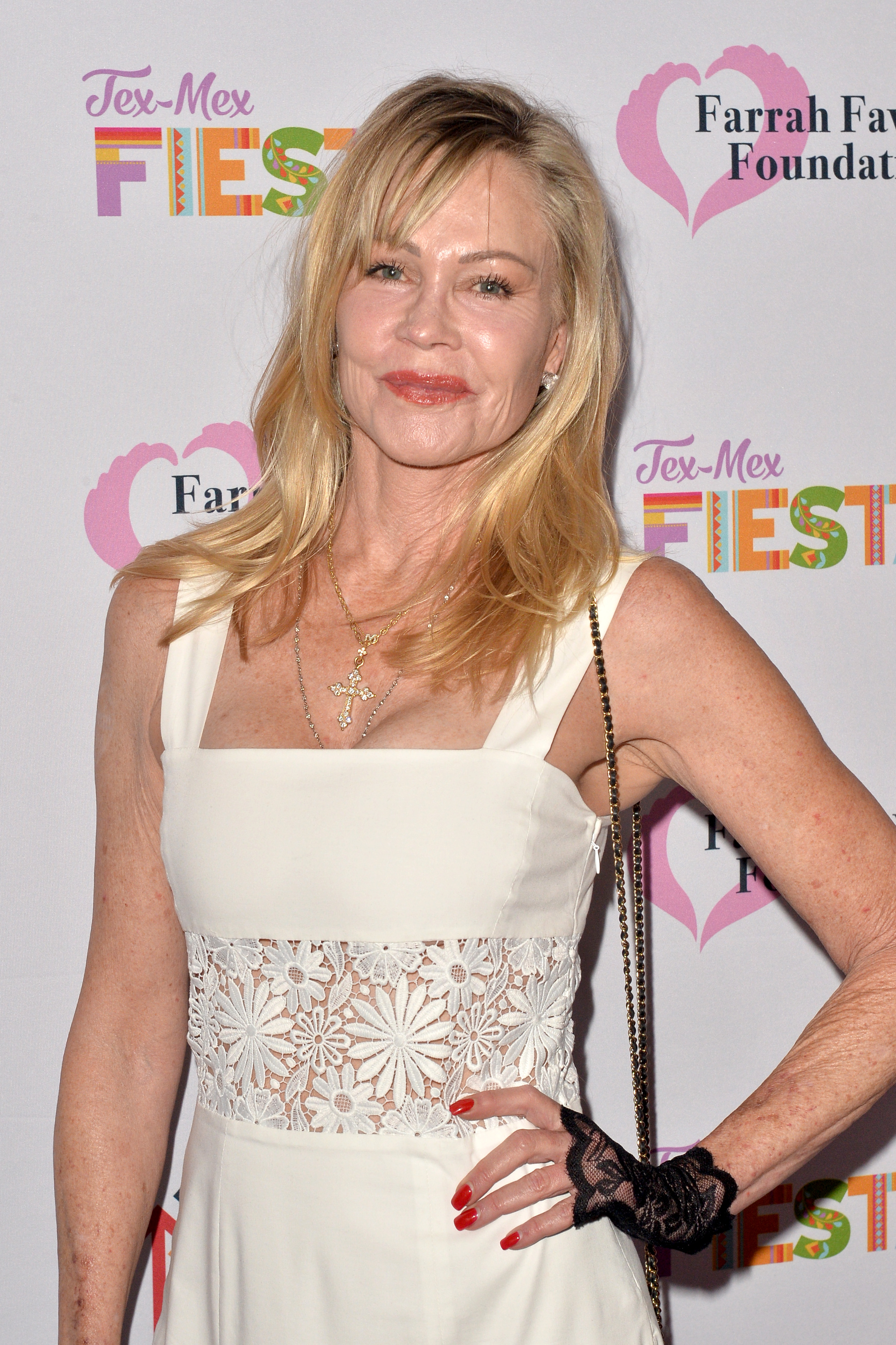 Melanie Griffith, seen in a white dress with a cutout at The Farrah Fawcett Foundation’s Tex-Mex Fiesta at Wallis Annenberg Center for the Performing Arts in 2019, has been proudly showing off her looks
