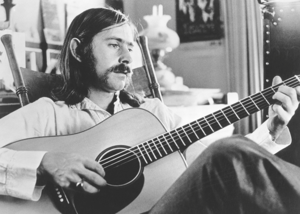 Norman Greenbaum poses with acoustic guitar.