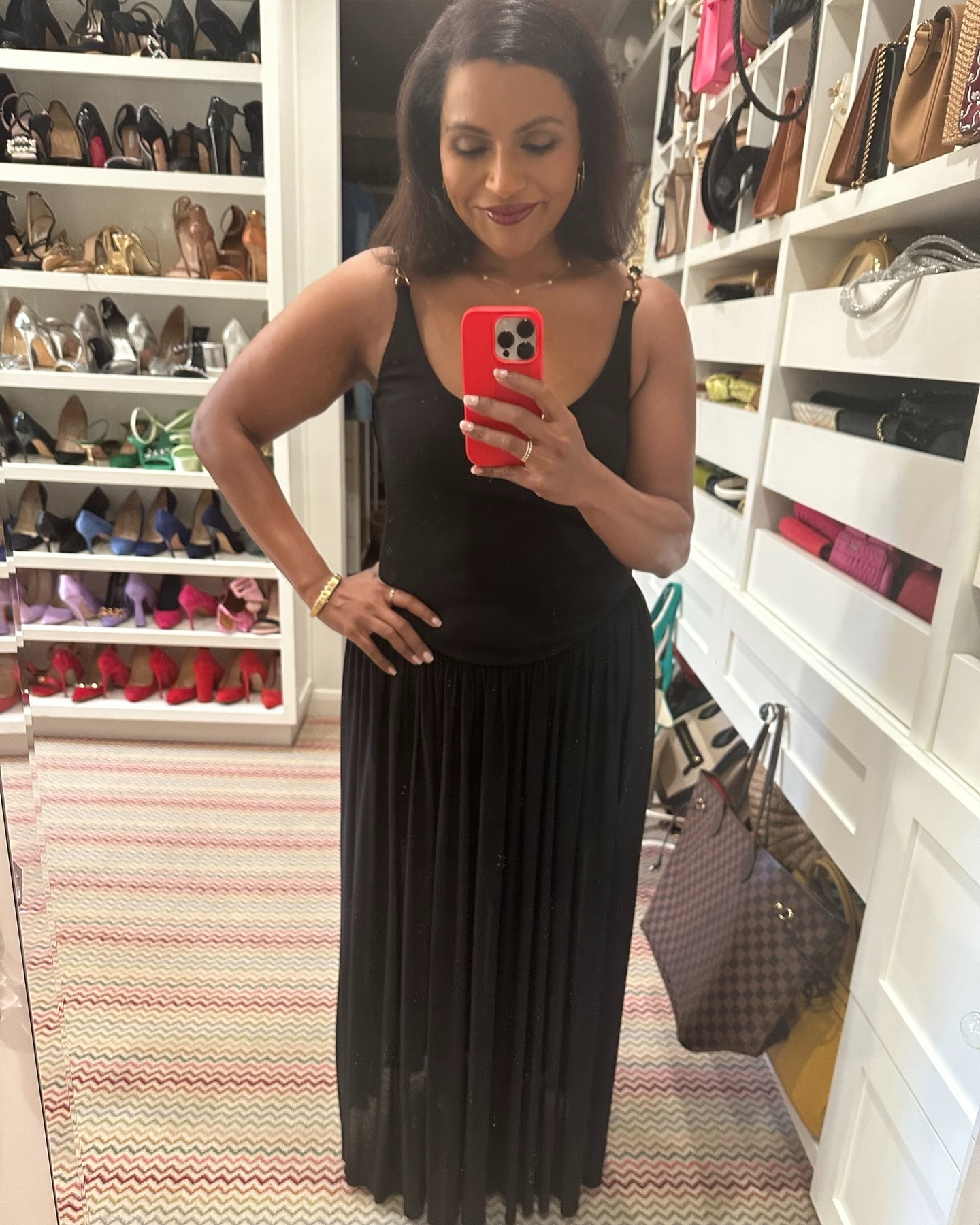 Mindy Kaling shows off her slimmed-down figure in a black dress while posing for a mirror selfie in her closet