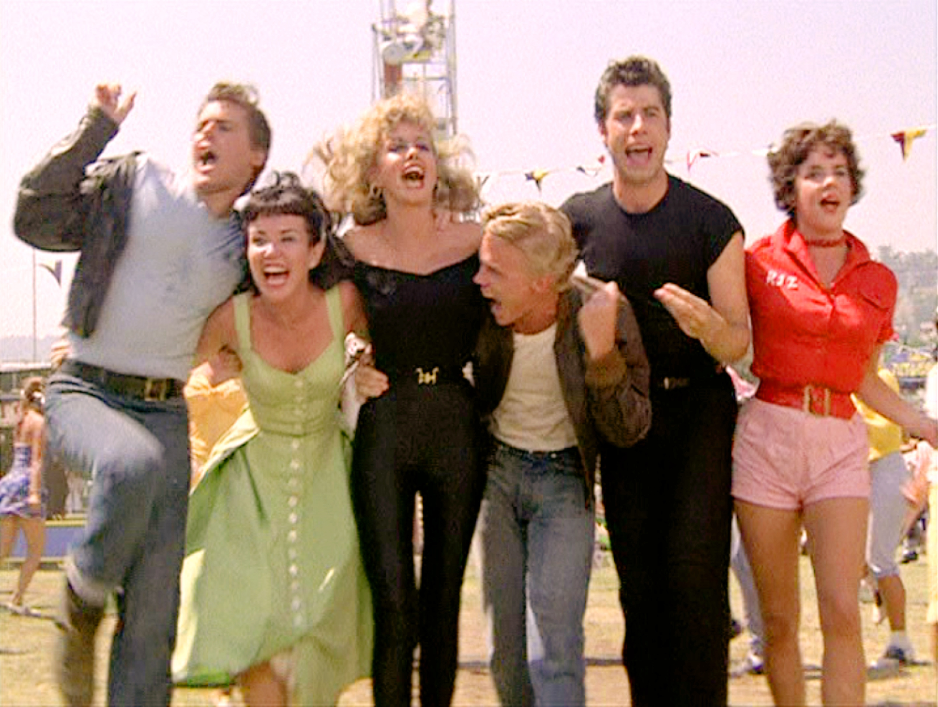 Grease stars Jeff Conaway as Kenickie, Jamie Donnelly as Jan, Olivia Newton-John as Sandy, Kelly Ward as Putzie, John Travolta as Danny Zuko, and Stockard Channing as Rizzo