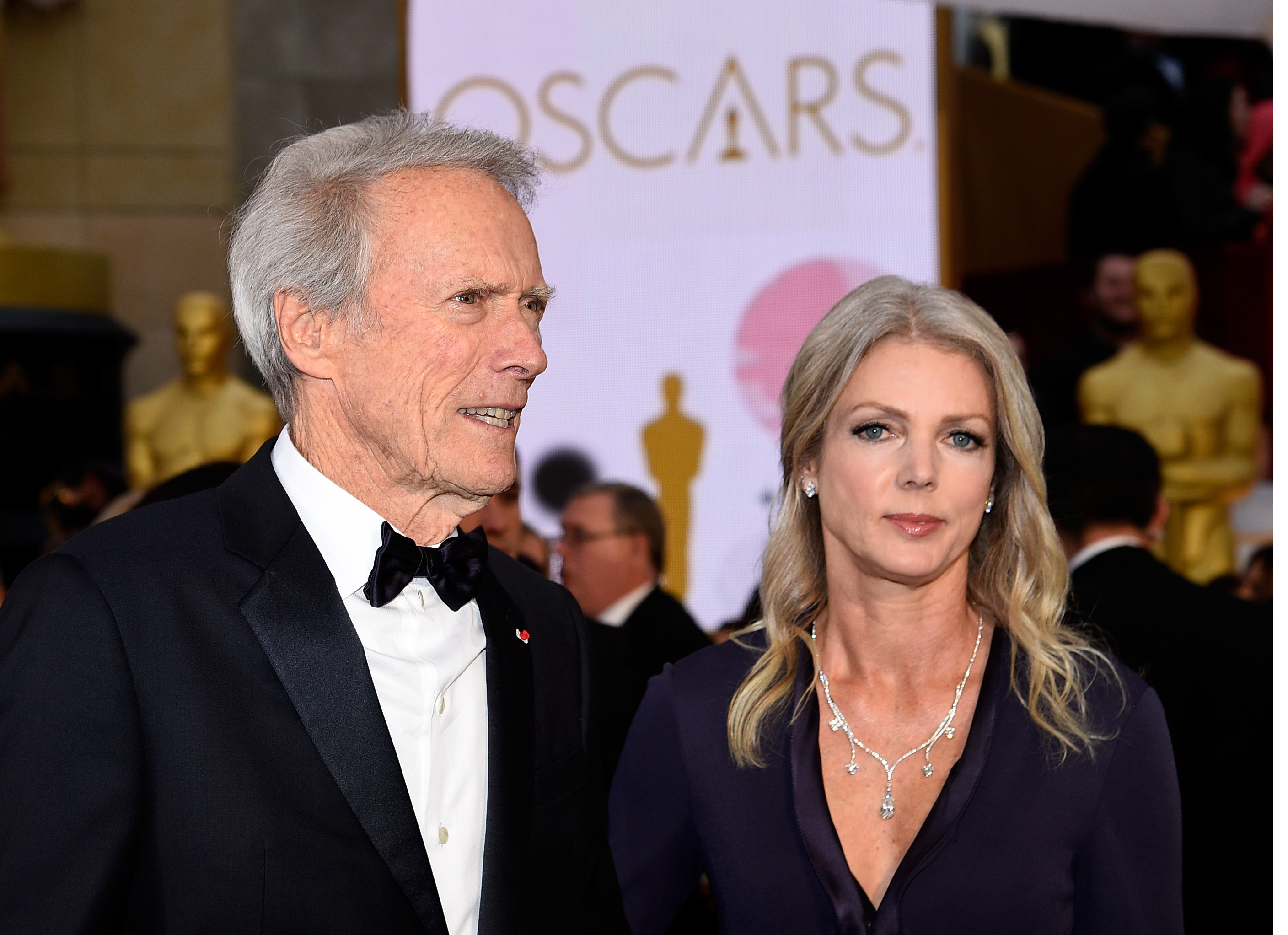 Clint Eastwood and Christina Sandera attend the 87th Annual Academy Awards at Hollywood & Highland Center on February 22, 2015, in Hollywood, California