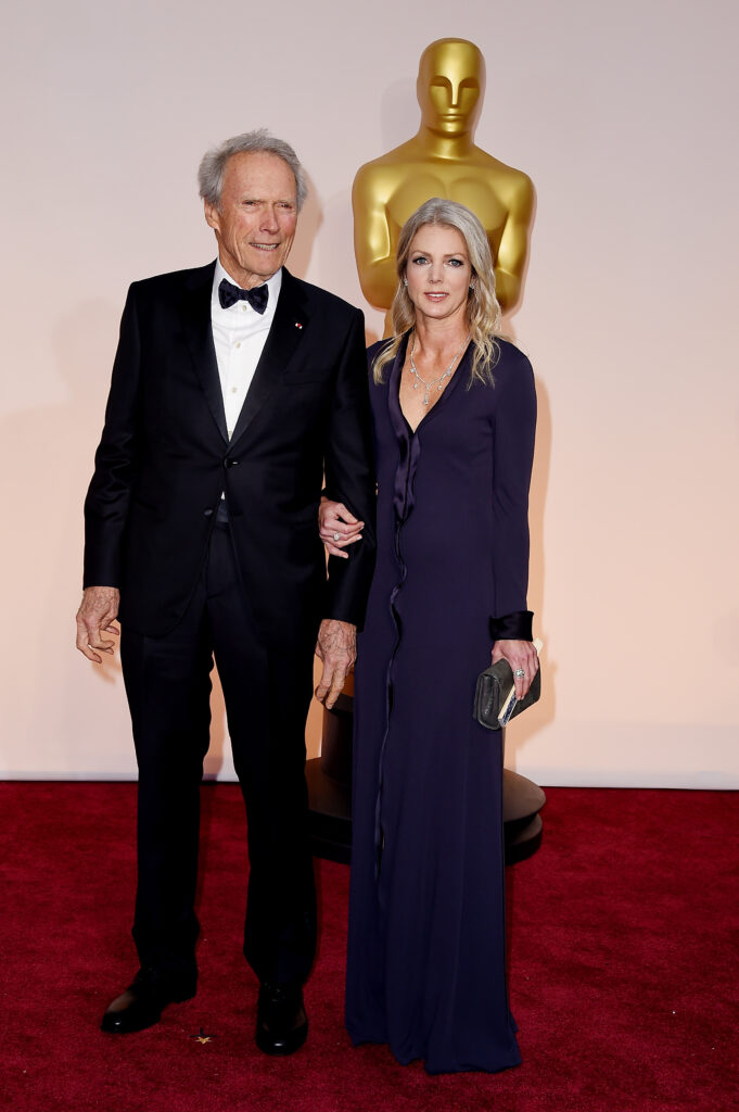 Director Clint Eastwood and Christina Sandera at the 87th Annual Academy Awards in 2015