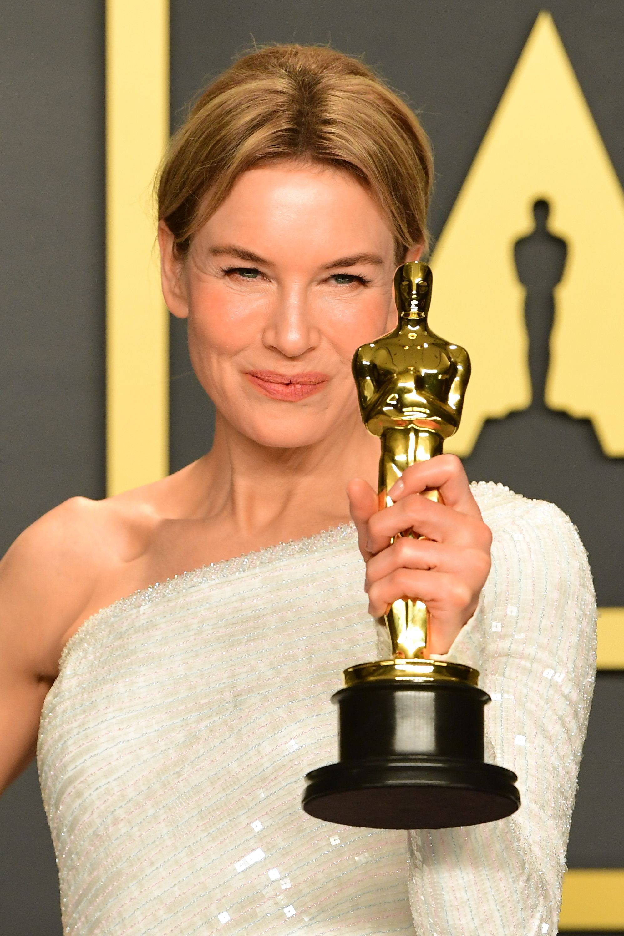 Renée Zellweger posing in the press room with the Oscar for Best Actress, which she won for Judy, at the 92nd Oscars on February 9, 2020