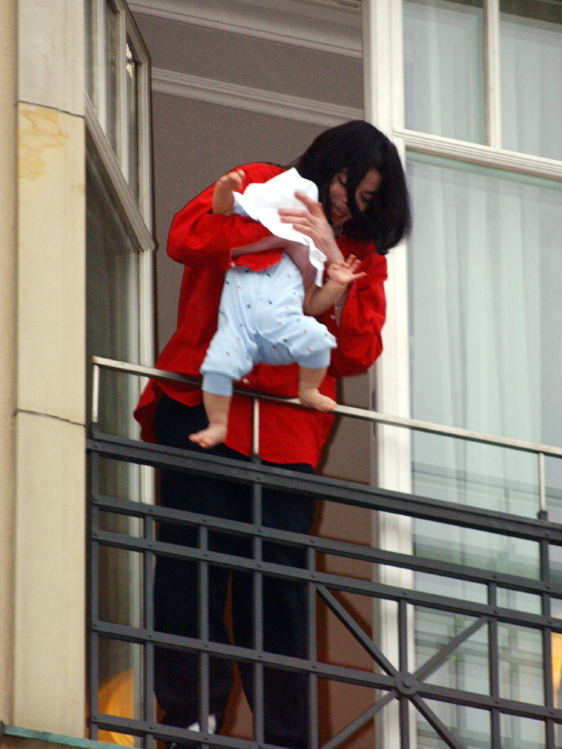 Michael Jackson holding his eight-month-old son- now known as Bigi- in 2008
