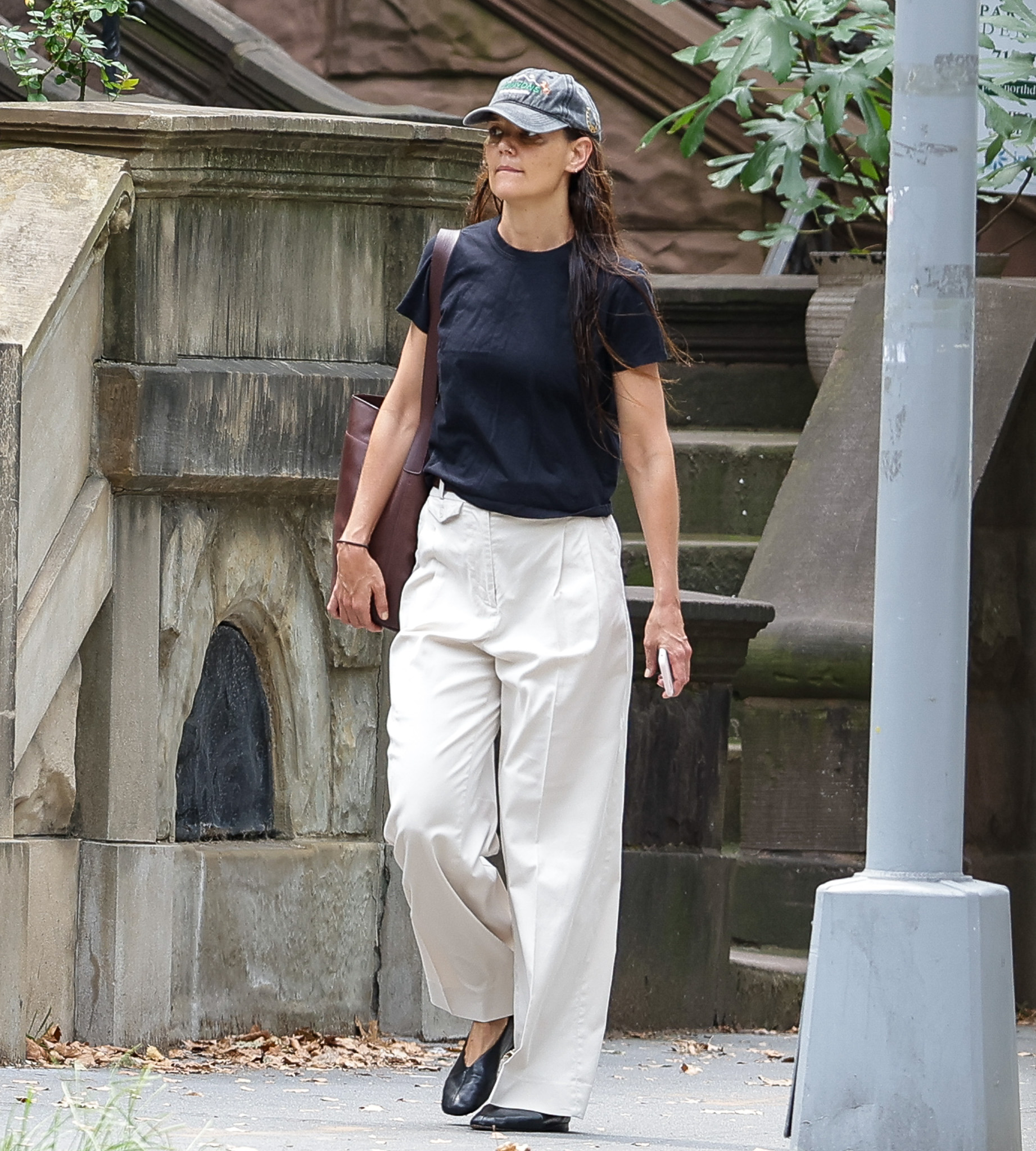 The actress kept it casual, rocking white pants and a chic black top, but hid her bruised face beneath a baseball cap