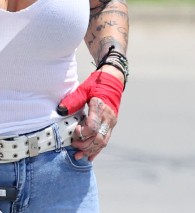 Kim Mathers appeared to have injured her thumb which was strapped and covered in a red bandage
