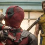 Deadpool smooches Dogpool while Wolverine looks annouyed