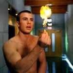 A shirtless Chris Evans snaps his fingers to create fire in "Fantastic Four."